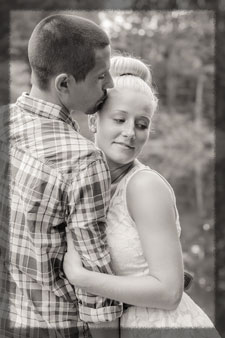 Photo of Brian kissing Amber's forehead